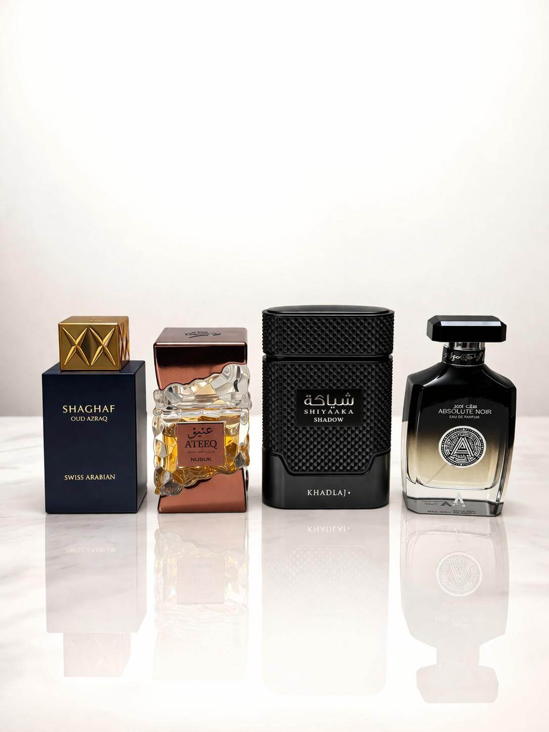 Luxury oud fragrance bundle with Shaghaf Oud Azraq, Ateeq, Shiyaaka Shadow and Absolute Noir perfumes on white background