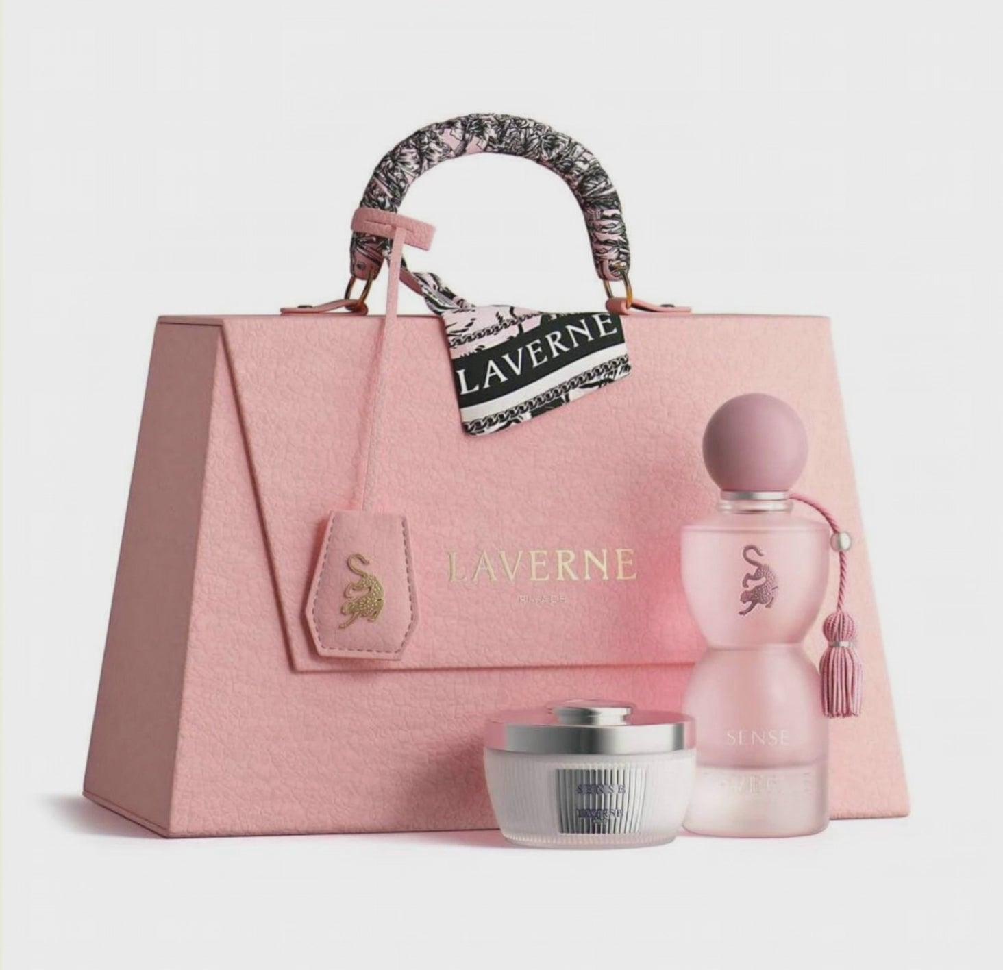 Pink handbag with 'Laverne' branding, including a perfume bottle and cream jar on a white background