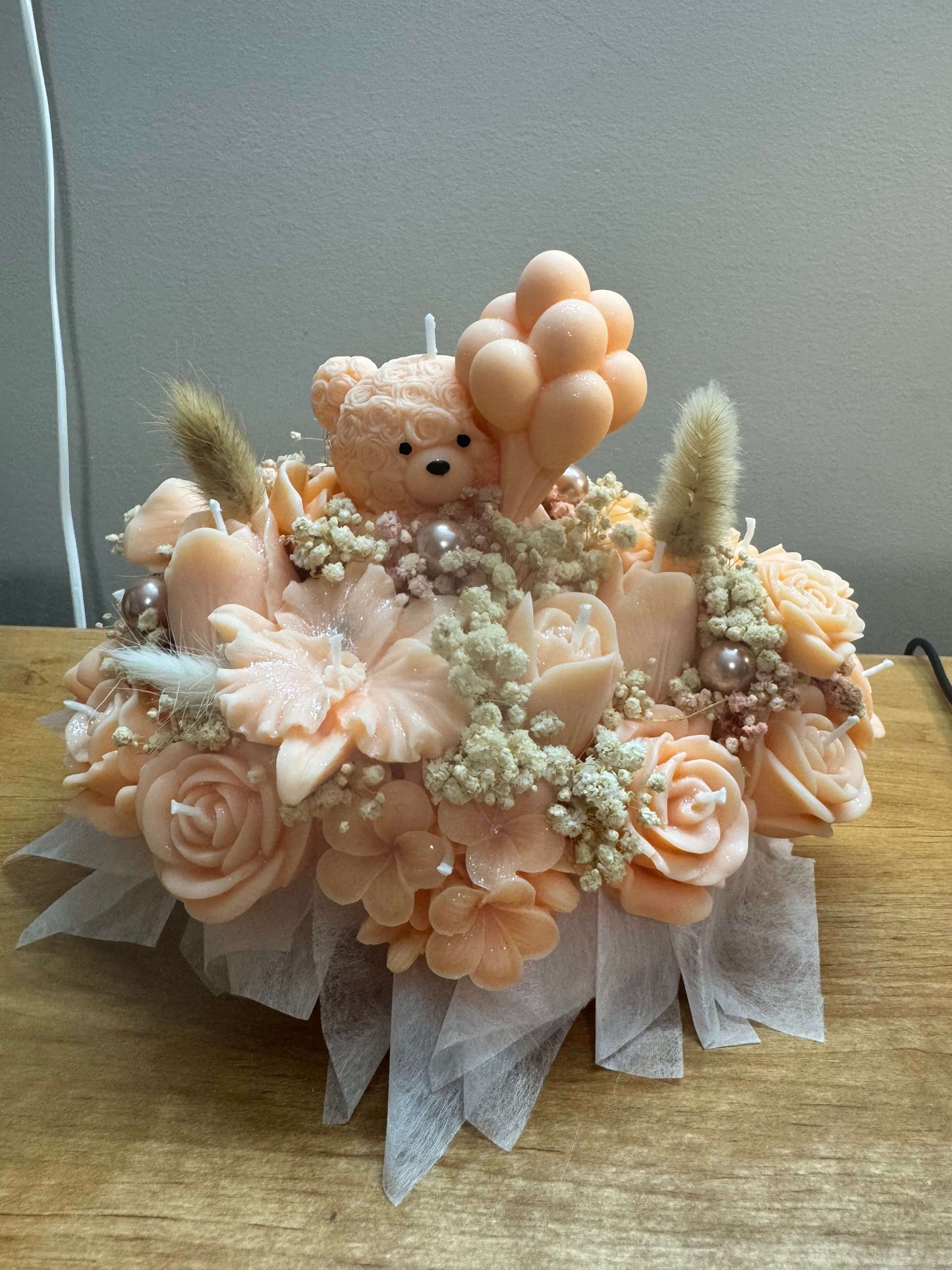 Handmade peach floral candle bouquet with teddy bear detail in ceramic base