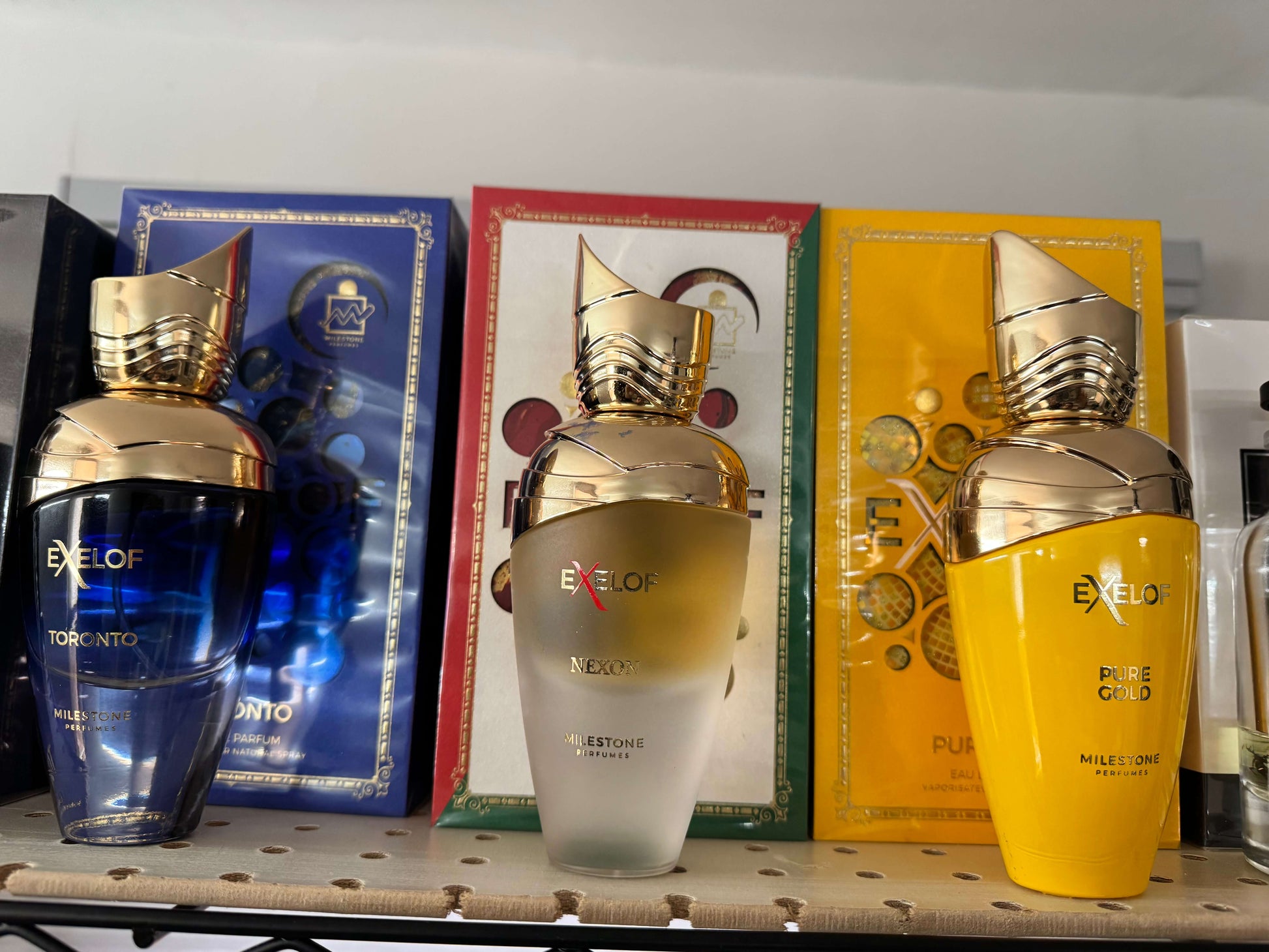 Exelof Luxury Trio Bundle by Milestone featuring Toronto, Nexon, and Pure Gold Eau de Parfum bottles with matching boxes arranged together on a clean background.
