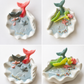 Handmade ocean shell candle with mermaid tail and marine decorations in ceramic base