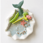 Handmade ocean shell candle with mermaid tail and marine decorations in ceramic base