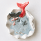 Handmade ocean shell candle with mermaid tail and marine decorations in ceramic base