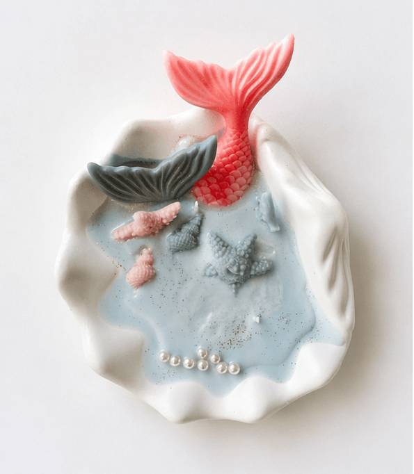 Handmade ocean shell candle with mermaid tail and marine decorations in ceramic base