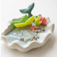 Handmade ocean shell candle with mermaid tail and marine decorations in ceramic base