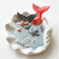Handmade ocean shell candle with mermaid tail and marine decorations in ceramic base
