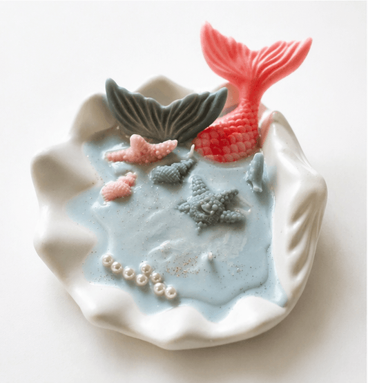 Handmade ocean shell candle with mermaid tail and marine decorations in ceramic base