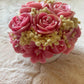 Handmade pink floral bouquet candle with rose-shaped wax flowers and decorative floral accents.