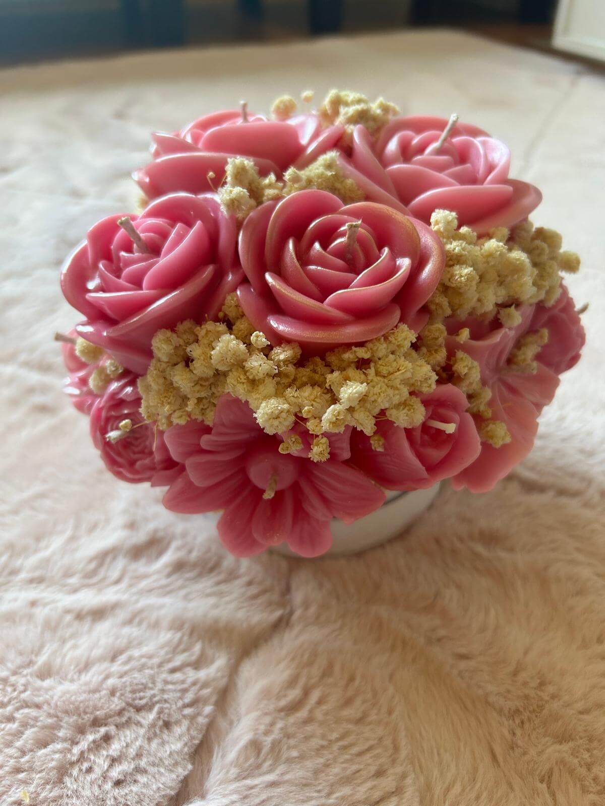 Handmade pink floral bouquet candle with rose-shaped wax flowers and decorative floral accents.