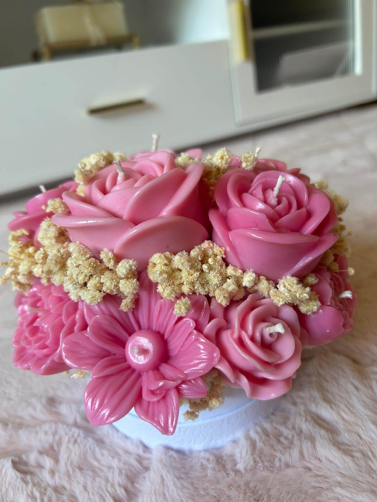 Handmade pink floral bouquet candle with rose-shaped wax flowers and decorative floral accents.