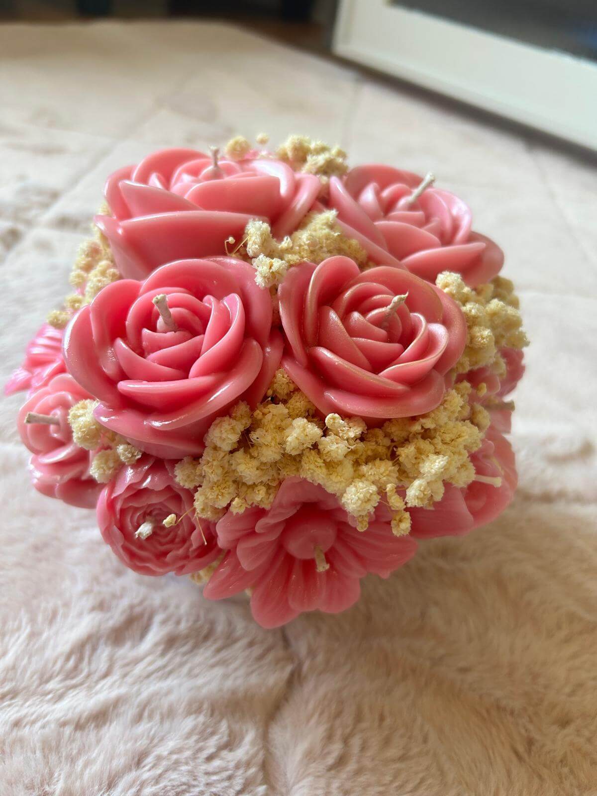 Handmade pink floral bouquet candle with rose-shaped wax flowers and decorative floral accents.