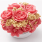 Handmade pink floral bouquet candle with rose-shaped wax flowers and decorative floral accents.