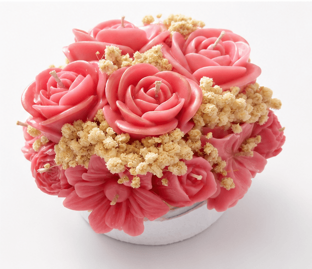 Handmade pink floral bouquet candle with rose-shaped wax flowers and decorative floral accents.