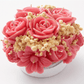 Handmade pink floral bouquet candle with rose-shaped wax flowers and decorative floral accents.