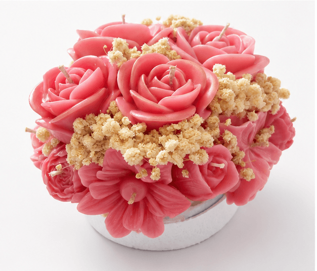 Handmade pink floral bouquet candle with rose-shaped wax flowers and decorative floral accents.
