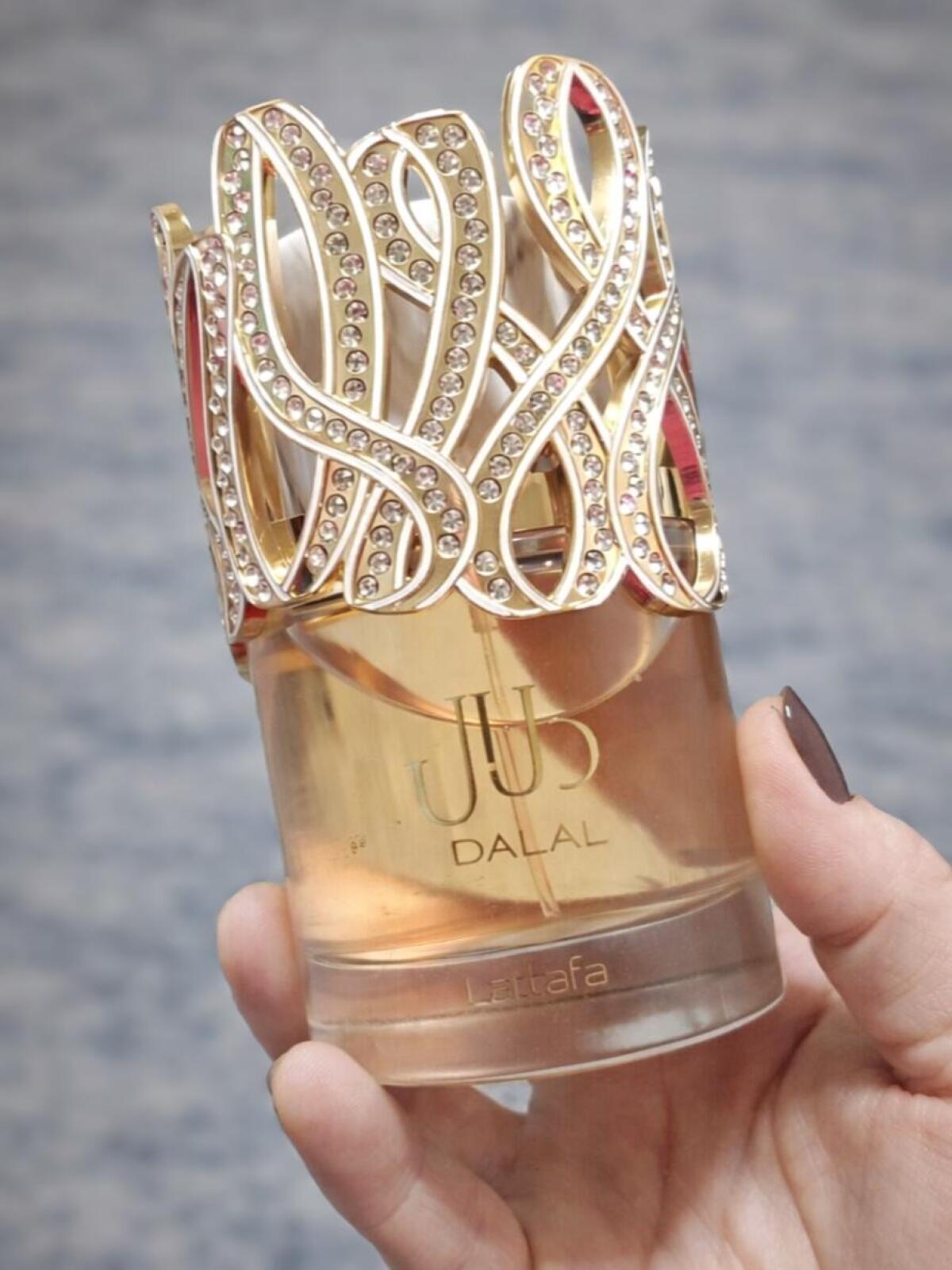 Lattafa Dalal Eau de Parfum 100ml (3.4oz) bottle with gold jeweled cap next to the Dalal retail box