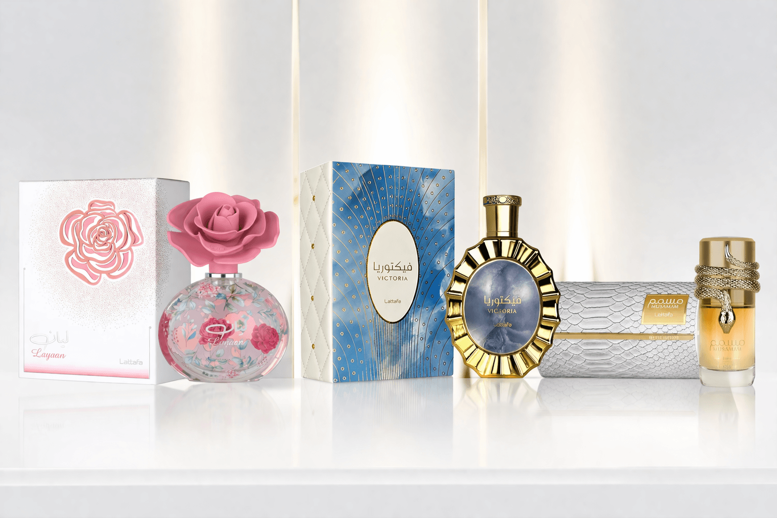 Lattafa fragrance bundle featuring Layaan, Victoria, and Musamam perfumes displayed on a clean white reflective surface