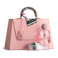 Pink handbag with 'Laverne' branding, including a perfume bottle and cream jar on a white background