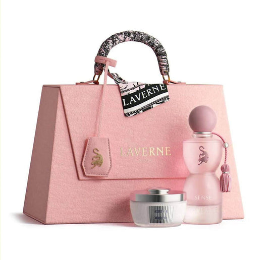 Pink handbag with 'Laverne' branding, including a perfume bottle and cream jar on a white background