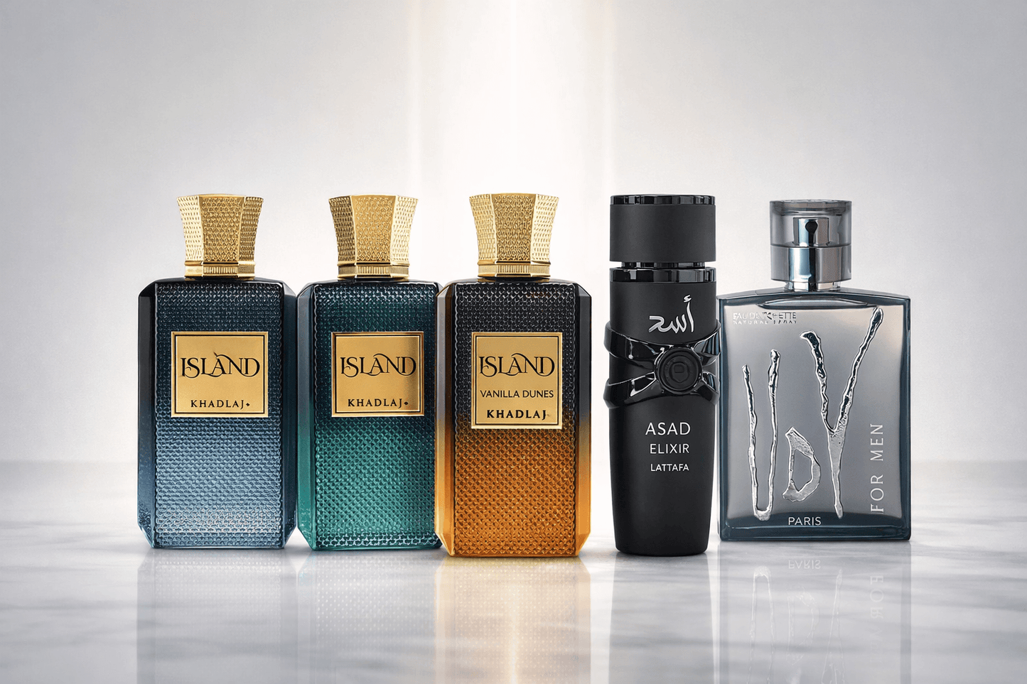Premium men’s fragrance bundle featuring Khadlaj Island Dreams Extrait de Parfum, Khadlaj Island Extrait de Parfum, Khadlaj Island Vanilla Dunes Extrait de Parfum, Lattafa Asad Elixir Eau de Parfum, and Ulric de Varens UDV For Men Eau de Toilette displayed on a marble surface with warm luxury lighting and decorative elements.