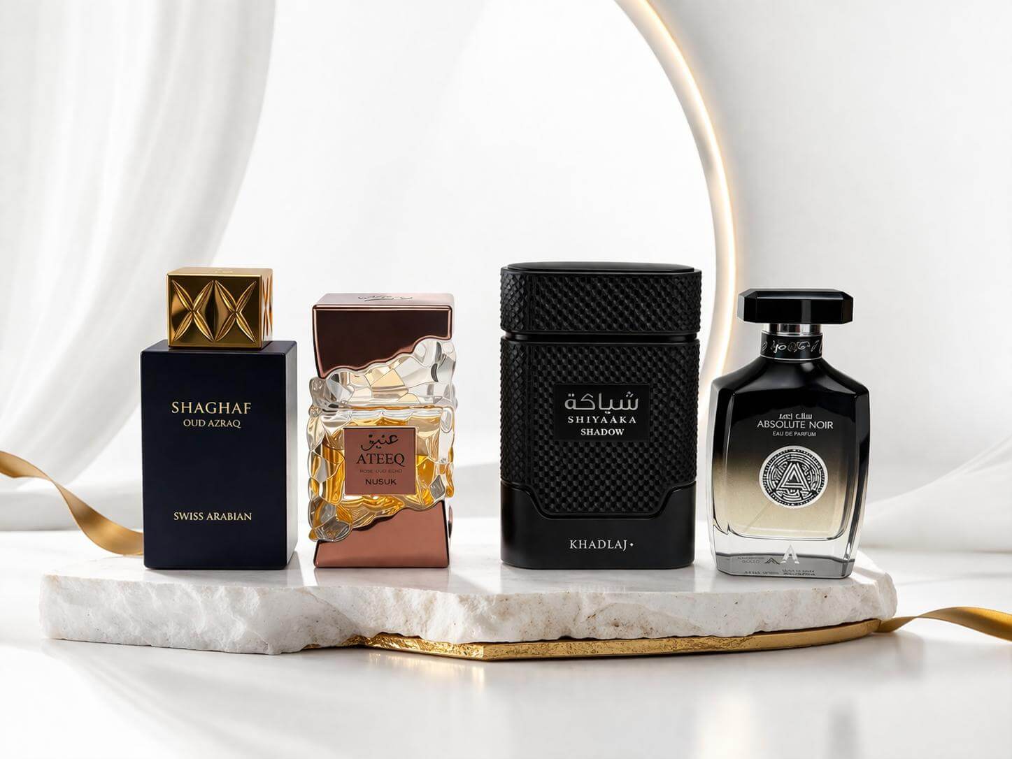 Luxury oud fragrance bundle with Shaghaf Oud Azraq, Ateeq, Shiyaaka Shadow and Absolute Noir perfumes on white background
