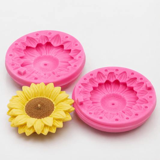 Pink two-piece sunflower silicone candle mold with detailed floral cavity and finished yellow sunflower candle.