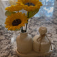 Sunflower candle arrangement — three yellow sunflower candles in ribbed ceramic vase with matching lidded jar on tray