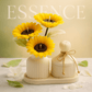 Sunflower candle arrangement — three yellow sunflower candles in ribbed ceramic vase with matching lidded jar on tray