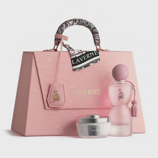 Pink handbag with 'Laverne' branding, including a perfume bottle and cream jar on a white background