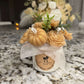 Handcrafted floral candle with tender baby powder essence. Elegant artisanal design, ideal for gifts or cozy luxury décor.